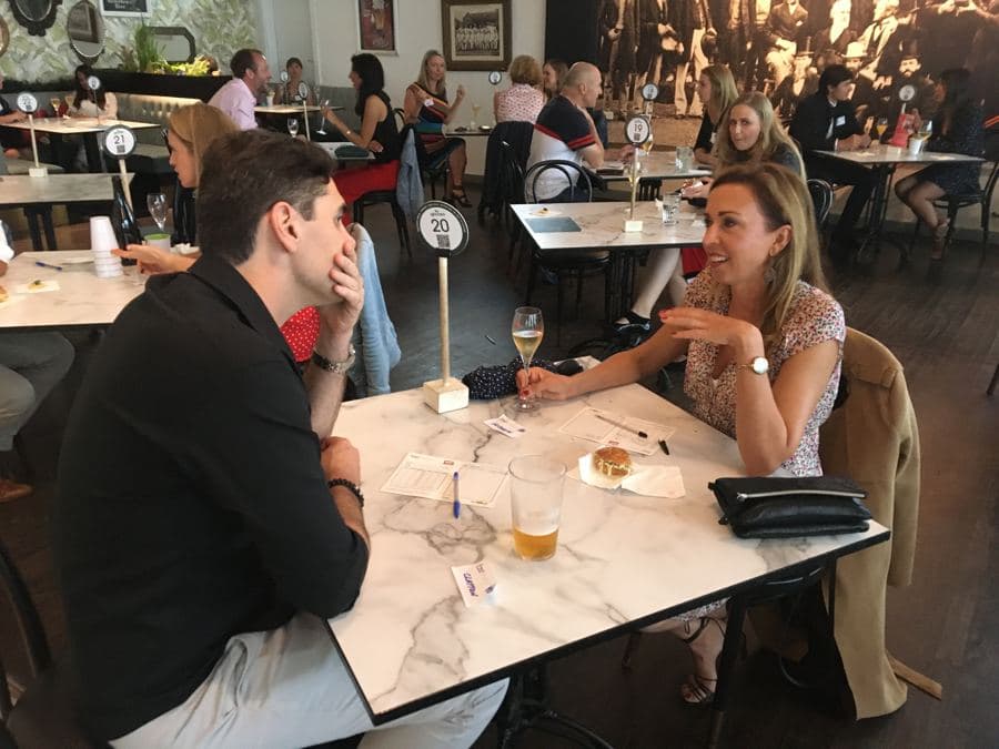 Couple chatting across a table at a FastMatch night